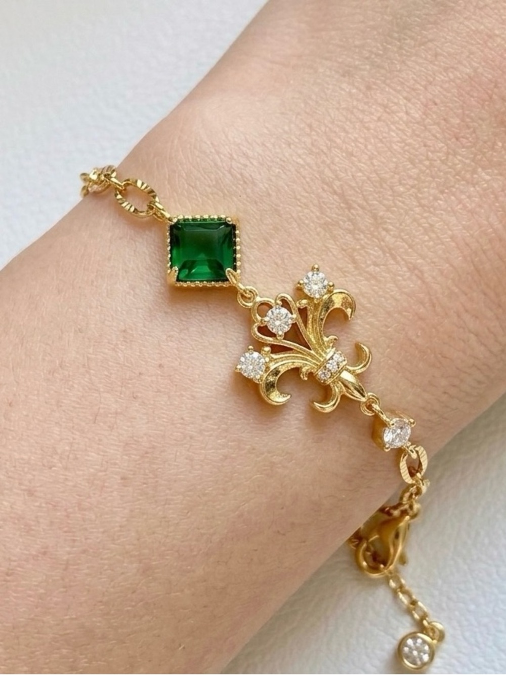 Gold-Plated Fleur de Lis Bracelet with Emerald Green Stone